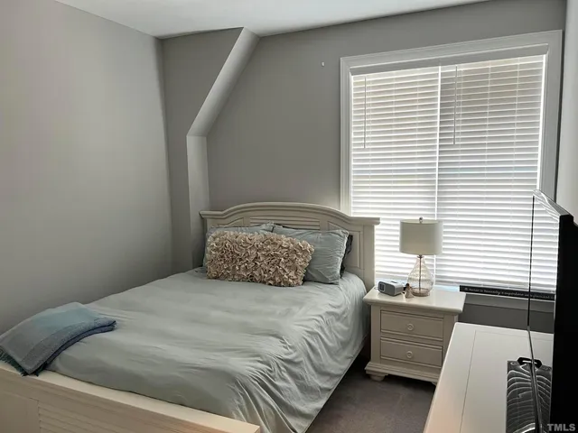 a bedroom with a large bed and a window