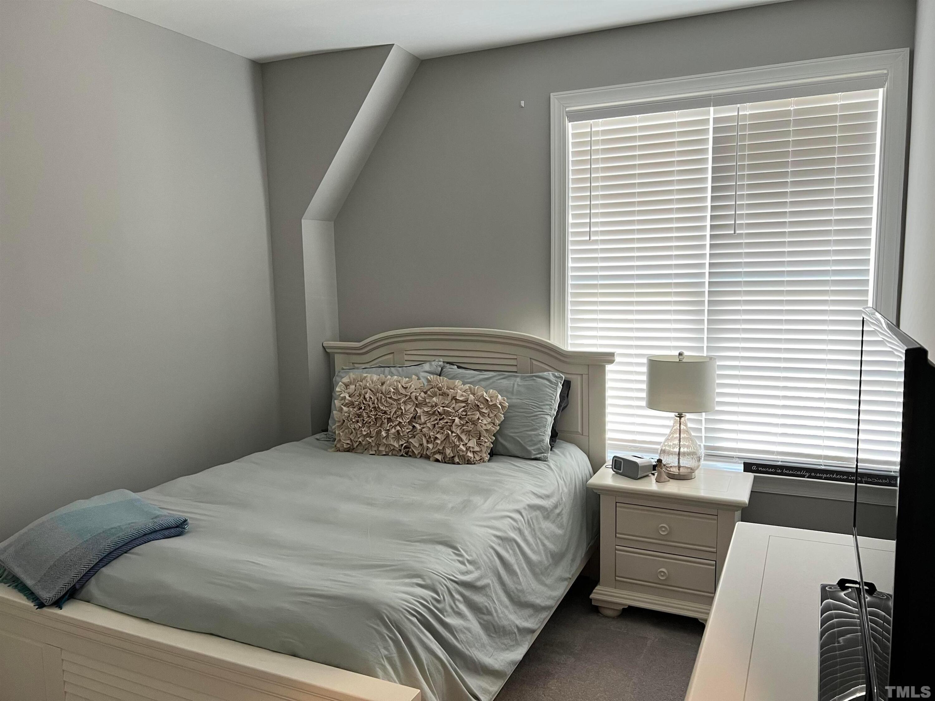 5807 Abingdon Ridge Place Raleigh, NC 27607 - Photo 12 of 24 a bedroom with a large bed and a window