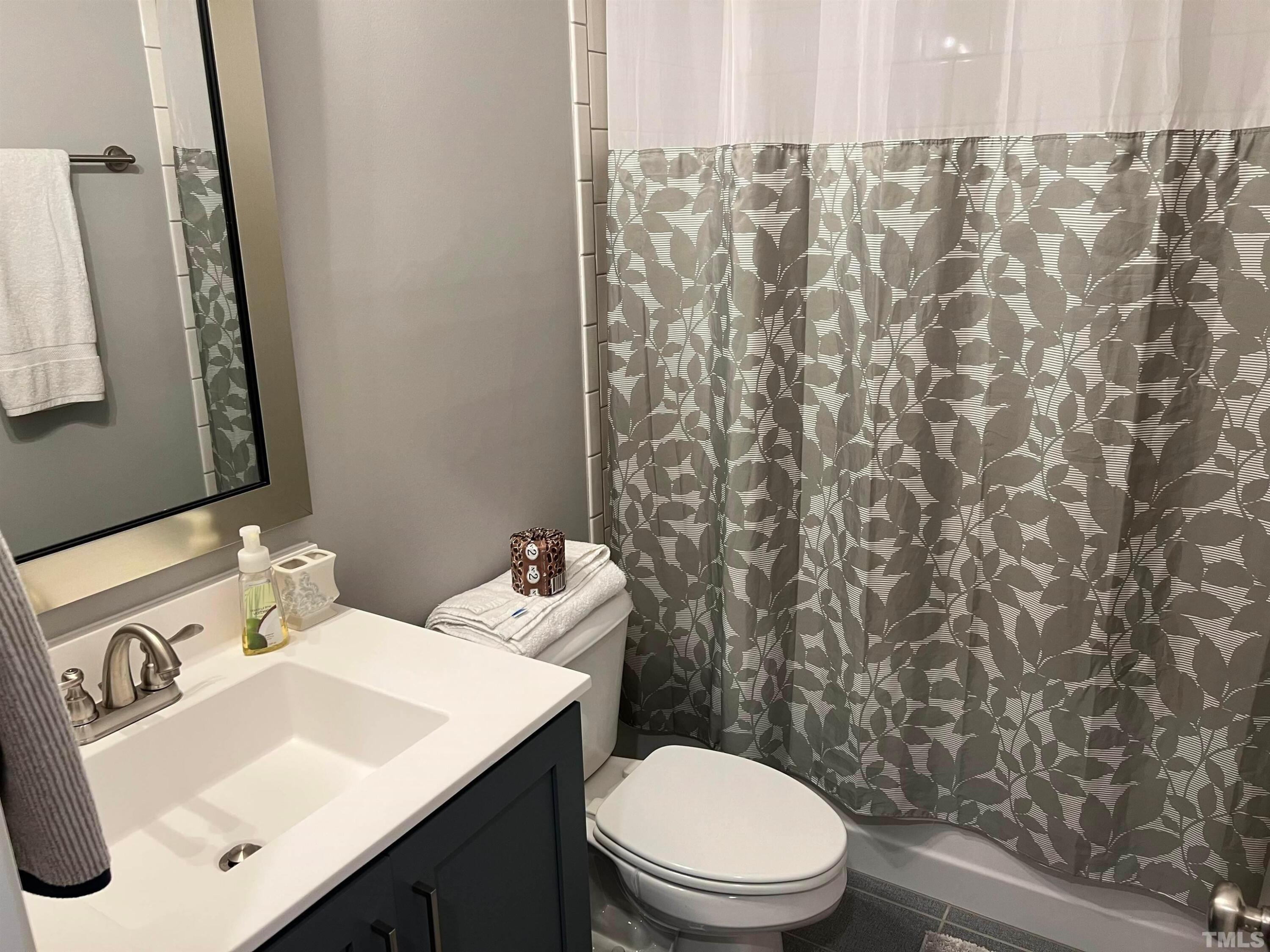 5807 Abingdon Ridge Place Raleigh, NC 27607 - Photo 13 of 24 a bathroom with a sink a toilet and a mirror