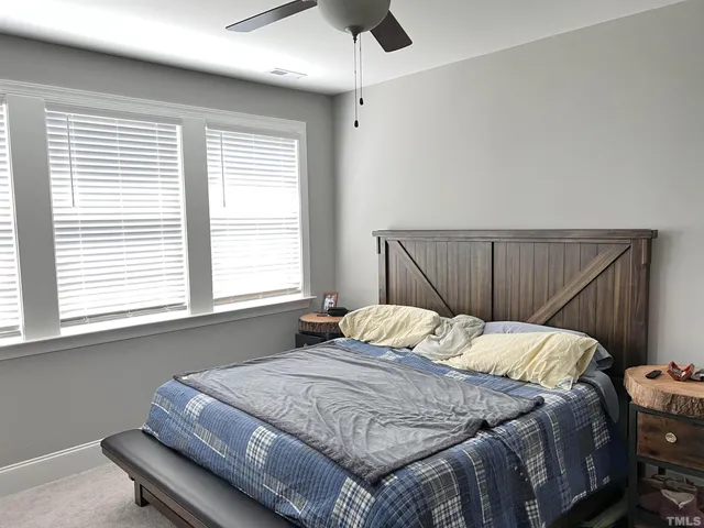 a bedroom with a bed and window