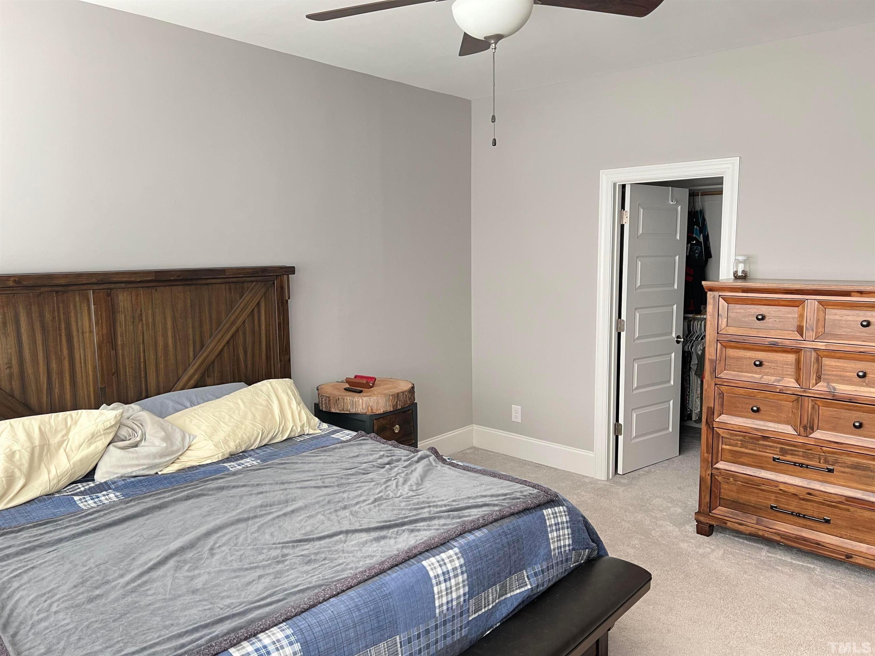 5807 Abingdon Ridge Place Raleigh, NC 27607 - Photo 15 of 24 a bedroom with a bed and a dresser