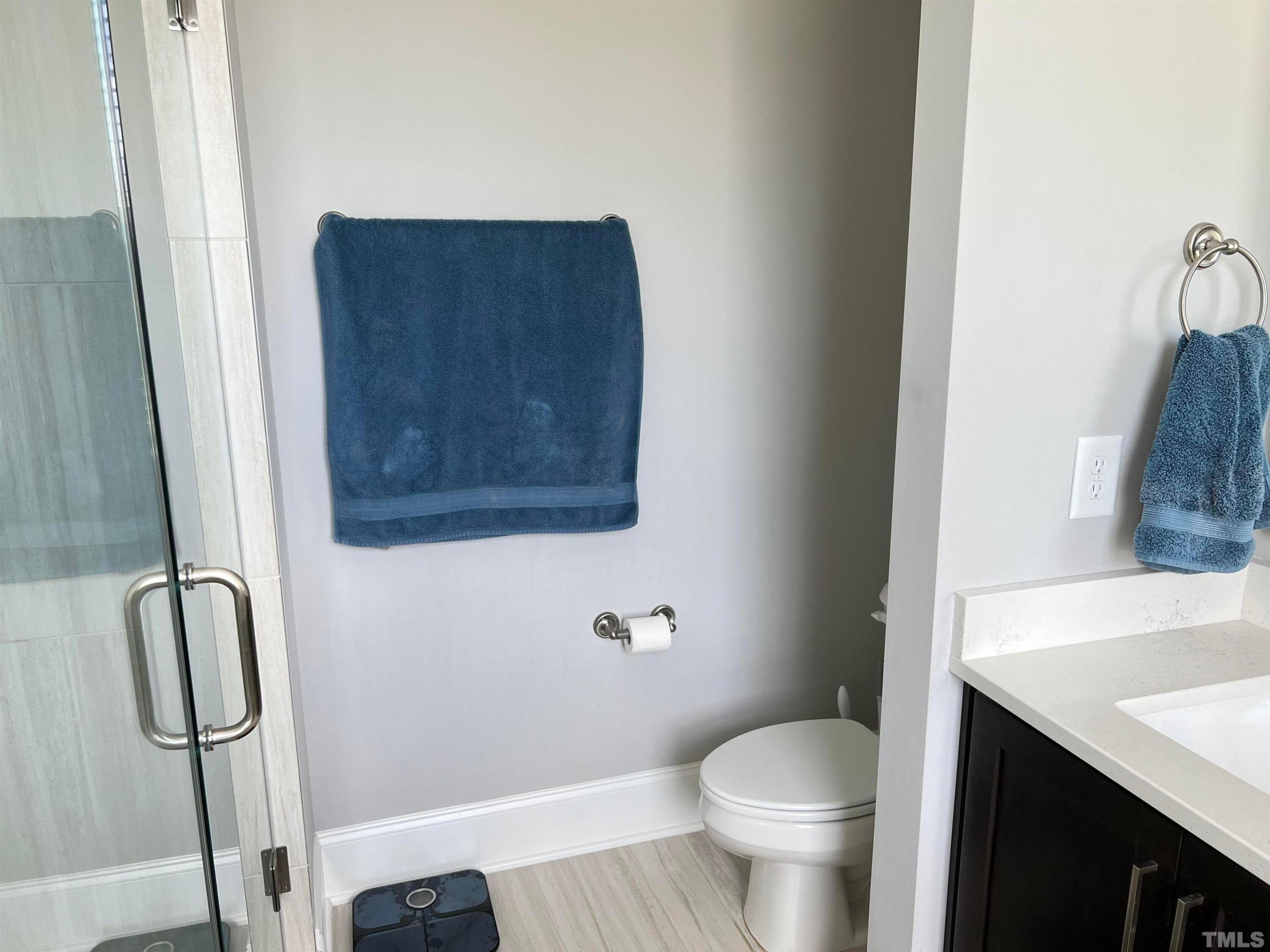 5807 Abingdon Ridge Place Raleigh, NC 27607 - Photo 18 of 24 a bathroom with a granite countertop toilet and a sink