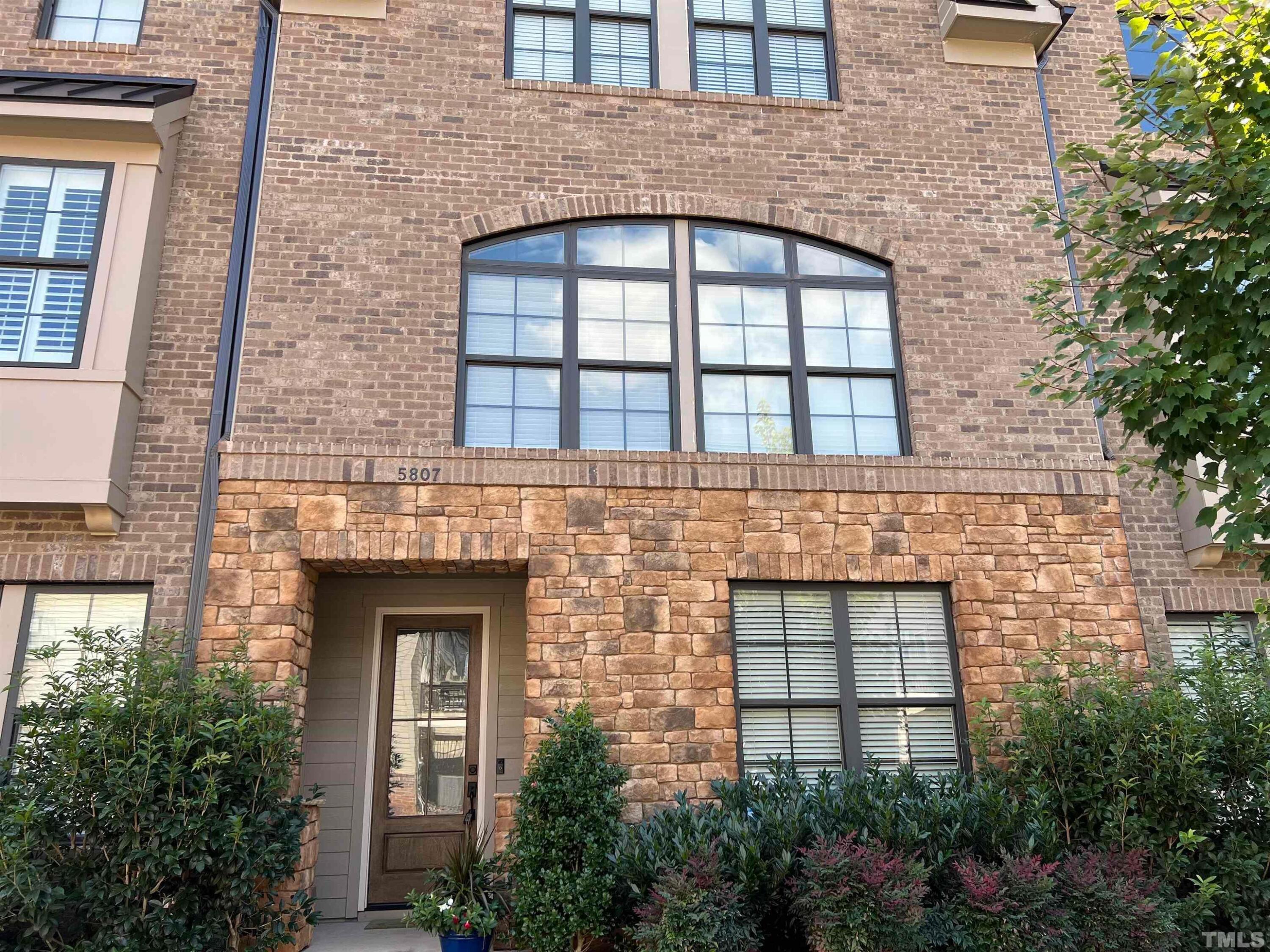 5807 Abingdon Ridge Place Raleigh, NC 27607 - Photo 21 of 24 front view of a brick house with a small yard