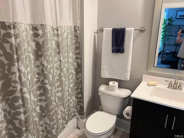 a white toilet sitting next to a bathroom sink