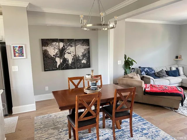 a view of a dining room with furniture and chandelier