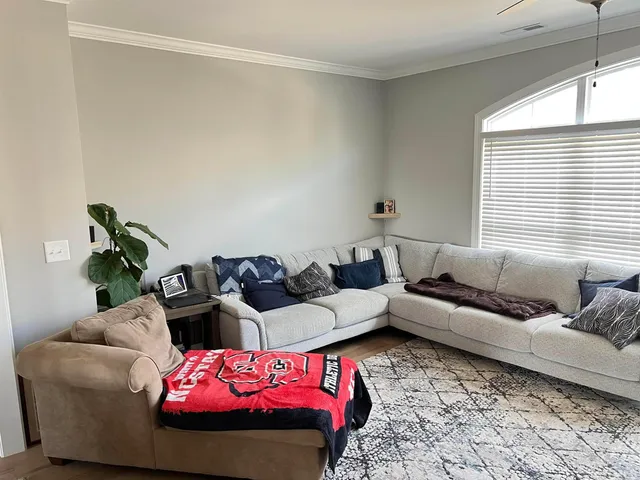 a living room with furniture and windows