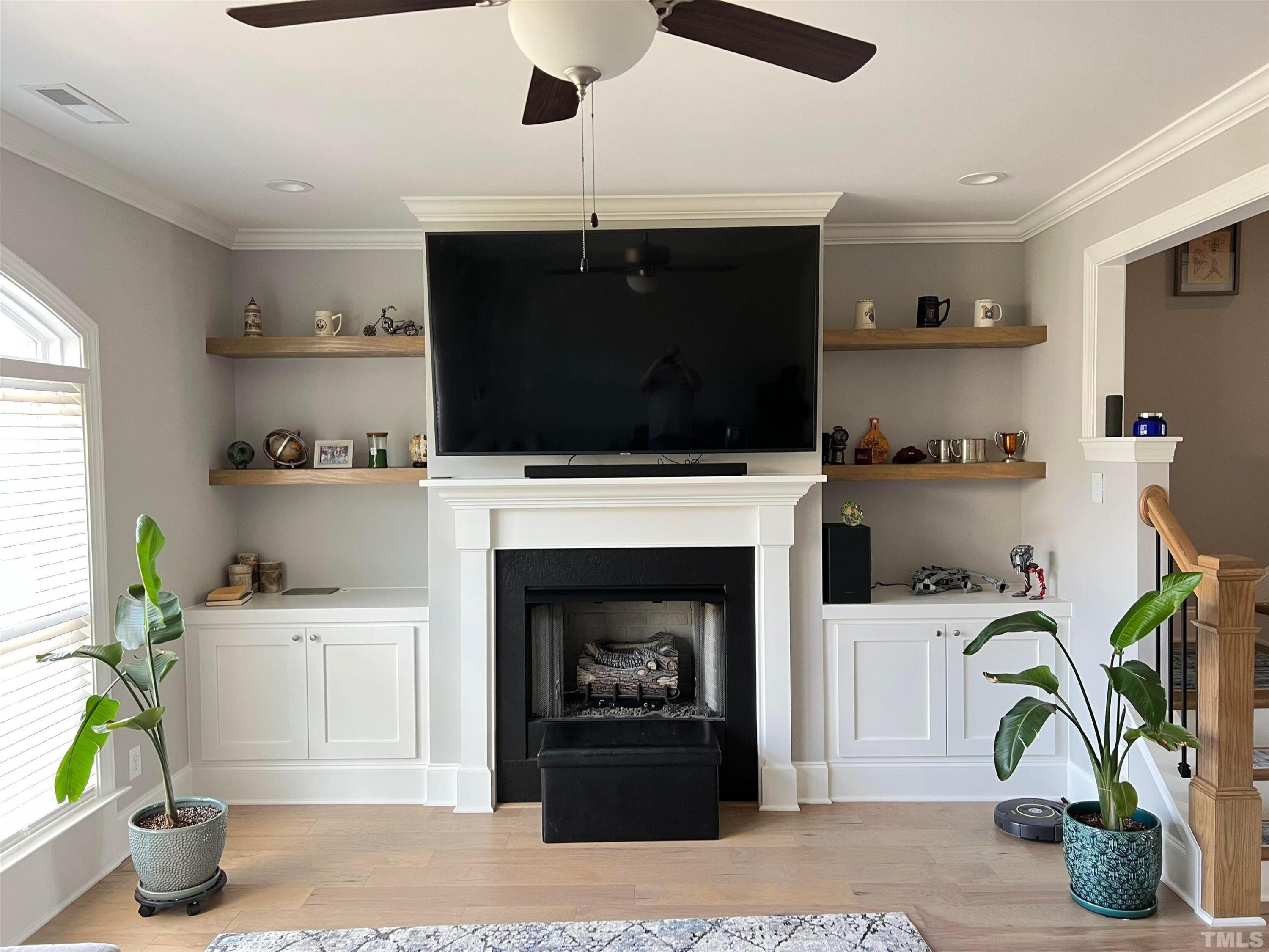 5807 Abingdon Ridge Place Raleigh, NC 27607 - Photo 10 of 24 a living room with furniture a flat screen tv and a fireplace
