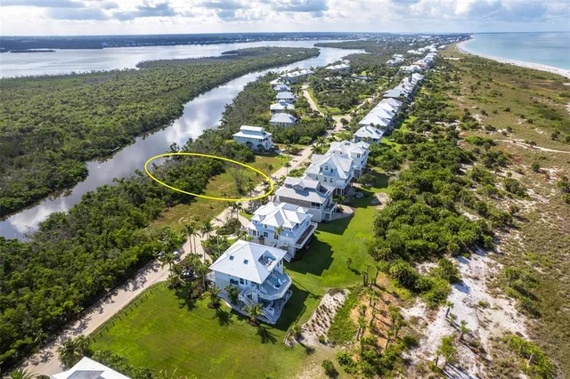 a view of a big yard with an ocean view