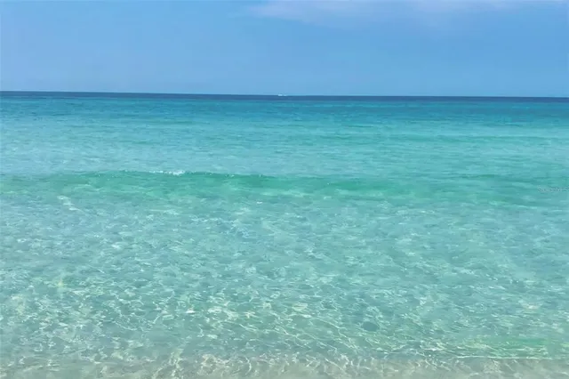 a view of a yard with wooden fence