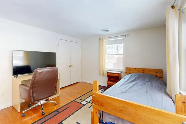 a bedroom with a bed and a chair