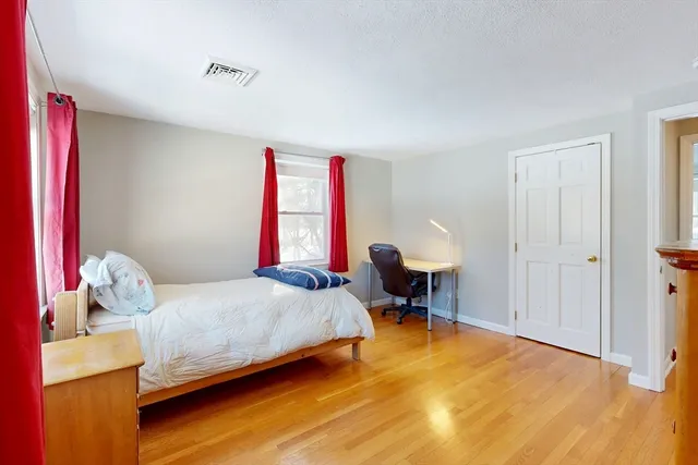 a spacious bedroom with a bed and a fireplace