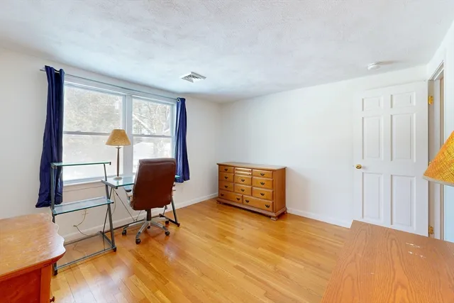 a spacious bedroom with a bed and a fireplace