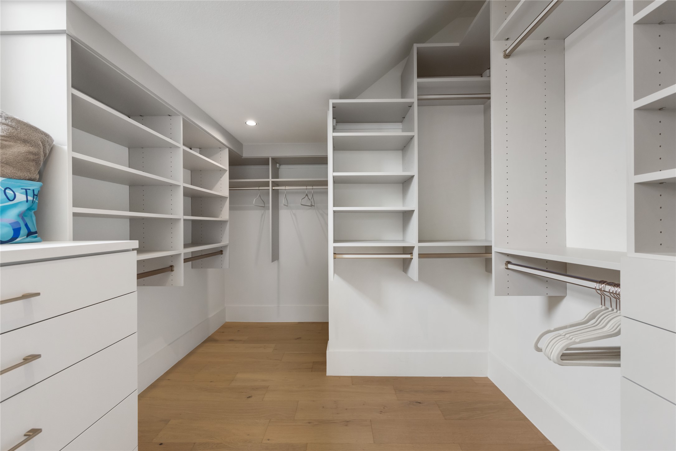 3201 Holton Street Austin, TX 78702 - Photo 20 of 39 An expansive walk-in closet boasts extensive custom built-in shelving, hanging rods, and a dedicated dresser unit to ensure flawless organization.