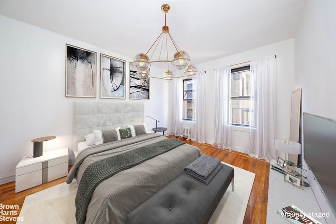 1793 Riverside Drive, Unit 6J Manhattan, NY 10034 - Photo 4 of 7 a bedroom with a bed and a flat screen tv