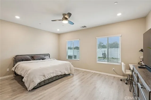 a bedroom with a large bed and a window