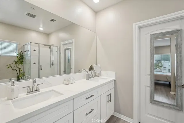 a bathroom with double vanity sinks and a mirror