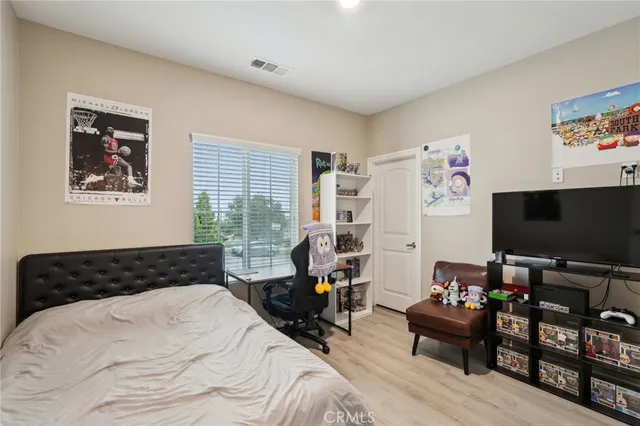 a bedroom with furniture and a flat screen tv