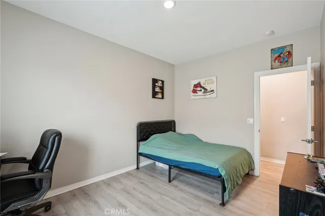 a bedroom with a bed and a chair