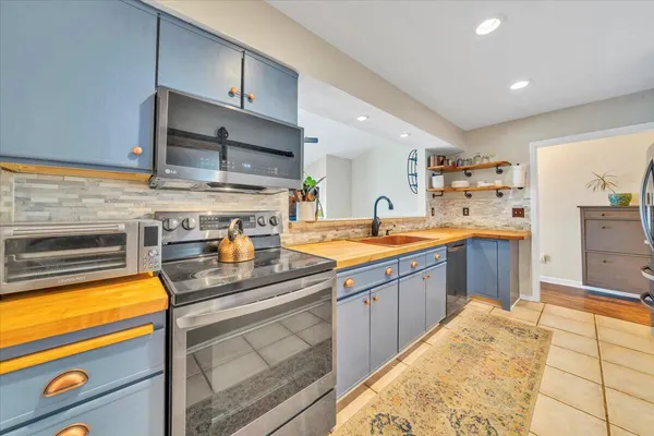 a kitchen with stainless steel appliances granite countertop a sink and cabinets