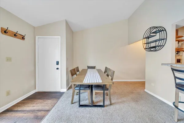 a view of a livingroom and a dining room with furniture window and wooden floor