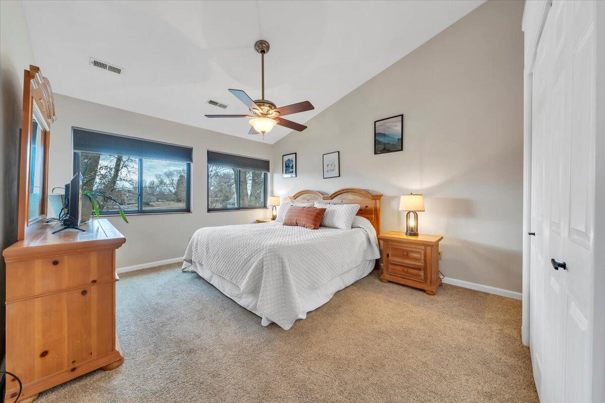 93 Peninsula Point Drive, Unit B5 Moneta, VA 24121 - Photo 21 of 48 a spacious bedroom with a bed and a chandelier
