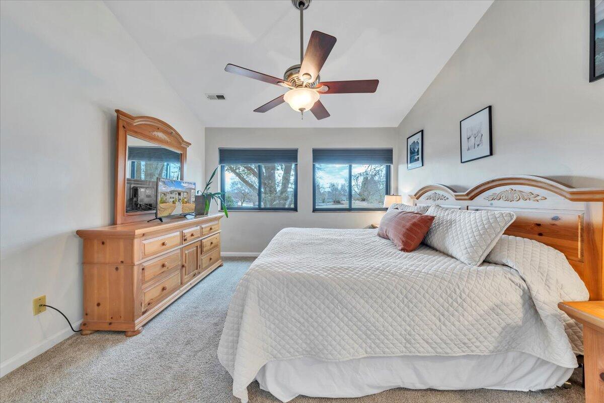 93 Peninsula Point Drive, Unit B5 Moneta, VA 24121 - Photo 22 of 48 a bedroom with a large bed and a chandelier
