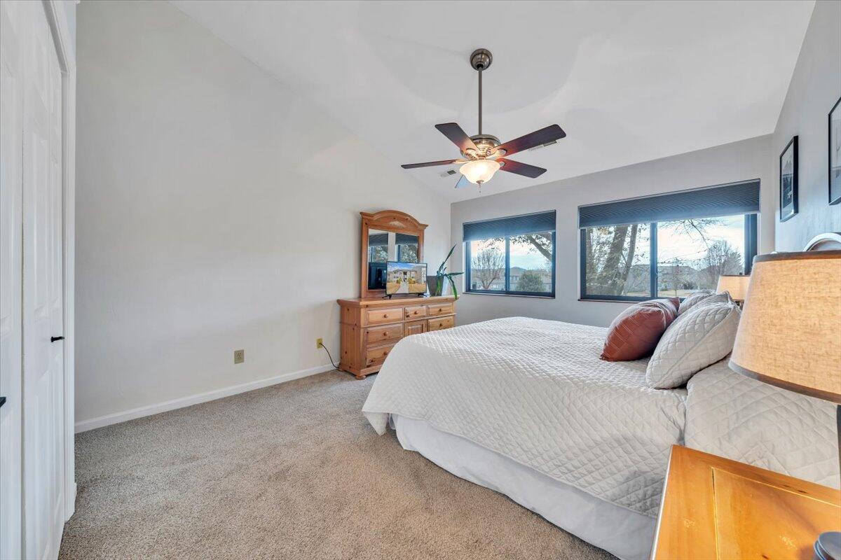 93 Peninsula Point Drive, Unit B5 Moneta, VA 24121 - Photo 24 of 48 a bedroom with a large bed and a chandelier