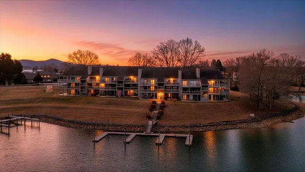 a view of a swimming pool with outdoor seating and a mountain view