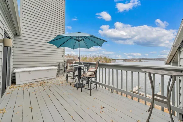 a view of a lake with a table and chairs