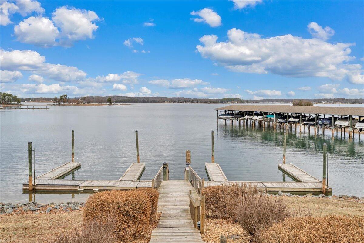 93 Peninsula Point Drive, Unit B5 Moneta, VA 24121 - Photo 36 of 48 a view of a lake with a table and chairs