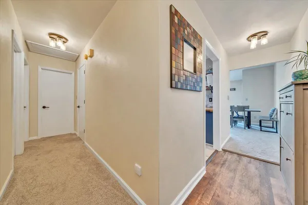 a view of livingroom with hardwood floor and a hallway