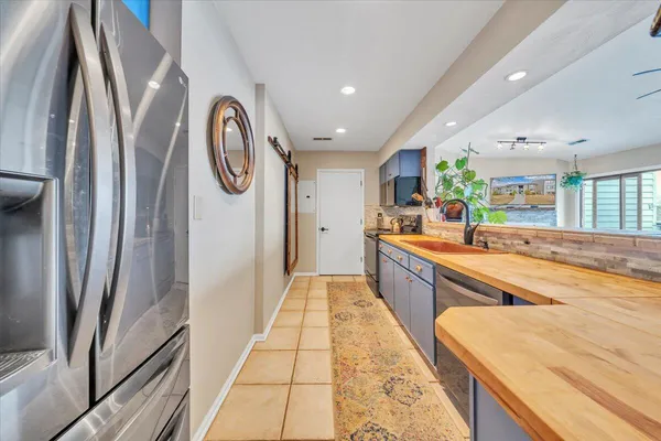a large kitchen with stainless steel appliances granite countertop a large stove top oven a sink and dishwasher