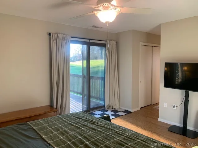 a bedroom with a bed a mirror and furniture