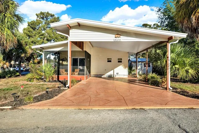 a view of a house with backyard porch and sitting area