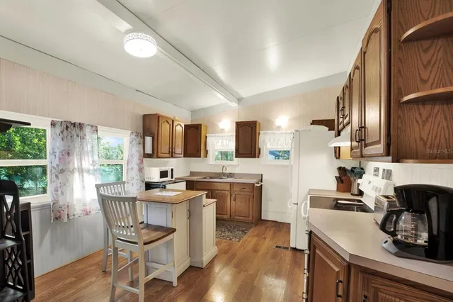 a kitchen with a table chairs stove and cabinets