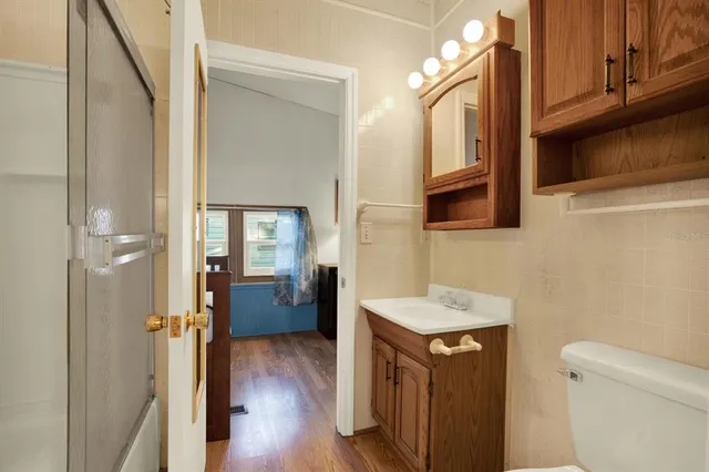 a bathroom with a sink a toilet and shower