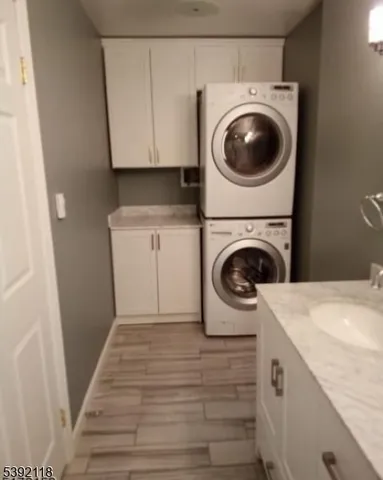 a utility room with sink dryer and washer