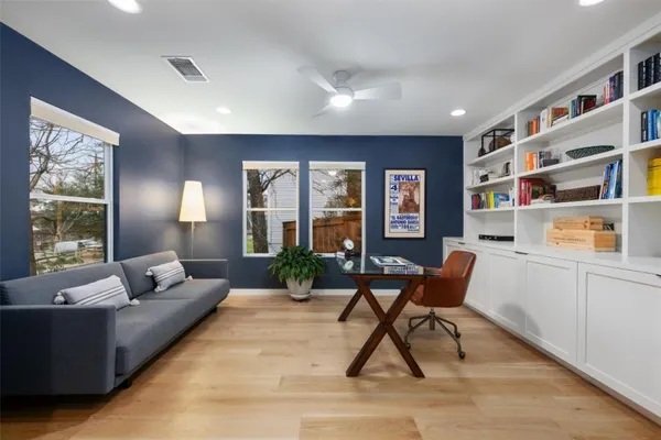 a living room with furniture and a potted plant
