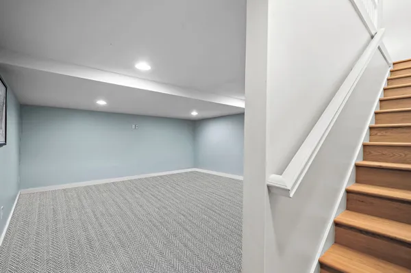 wooden floor in an empty room with stairs