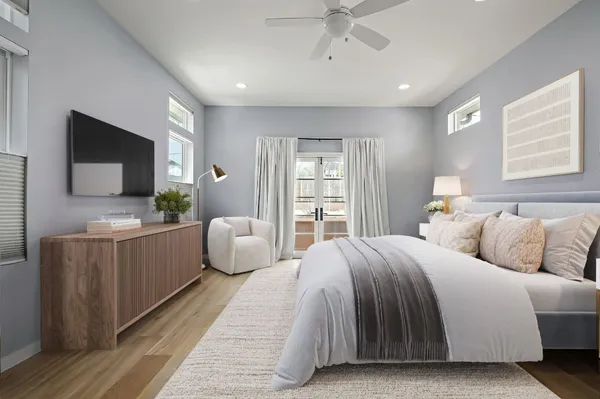 a bedroom with a bed and a flat screen television