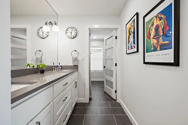 a spacious bathroom with a double vanity sink and a mirror
