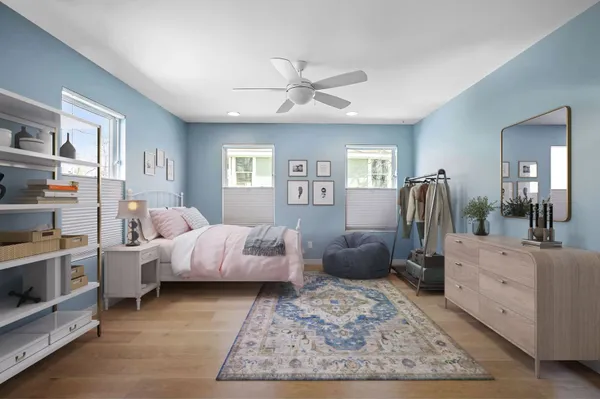 a bed room with furniture and wooden floor