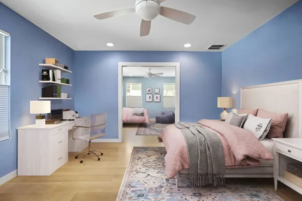 a bedroom with a bed and a chandelier