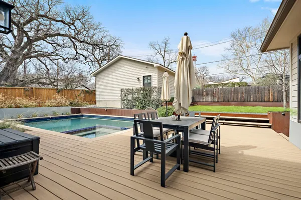 a view of a chairs and table on the wooden deck