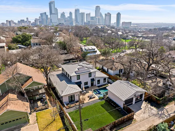 an aerial view of a residential apartment building with a yard and lake view
