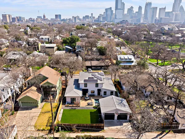 an aerial view of residential houses with yard
