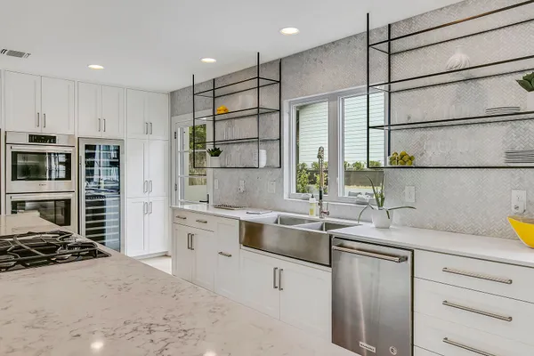 a kitchen with stainless steel appliances a sink stove and refrigerator