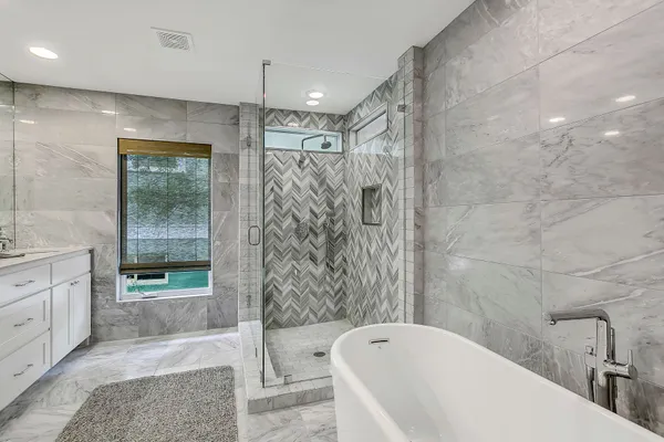 a bathroom with a bathtub and shower