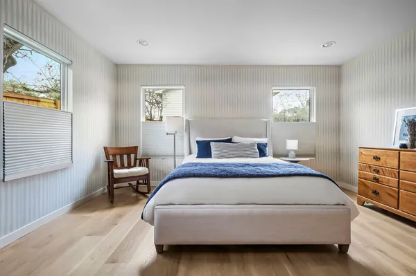 a spacious bedroom with a bed and a window