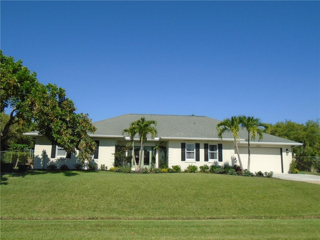 2185 Southeast Harding Street Port St. Lucie, FL 34952 - Photo 1 of 34 a front view of a house with a garden